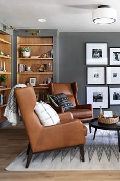 a living room filled with lots of furniture and pictures on the wall next to bookshelves