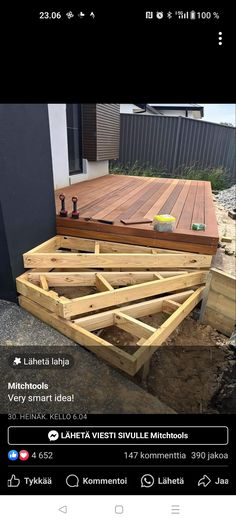 a wooden deck being built in front of a building with lots of wood planks