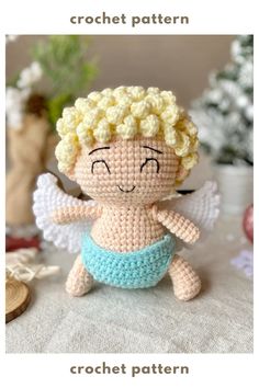 a small crocheted angel sitting on top of a table