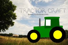 a green tractor is sitting in the middle of a field