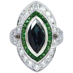 This Art deco inspired ring is centered with a bezel-set marquise shaped blue Sapphire, surrounded by Tsavorites 0.92 carat and round brilliant-cut Diamond 1.24 carats set in 18 karat White Gold. The ring is currently a size 52 (6 1/4 US) , with easy adjustment up or down. Width: 2.0 cm Length: 2.6 cm Ring Size: 52 "We first opened doors in 1980 when it was then situated in the vicinity of the Victory Monument; a small and modest storefront with a couple of counters. From its humble beginnings t Radiant Diamond Rings, Round Diamond Ring, Blue Sapphire Diamond, Diamond Ring Settings, Radiant Diamond, Diamond Star, Pretty Rings, Art Deco Inspired, Green Tourmaline