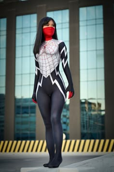 a woman in a spider suit and red mask