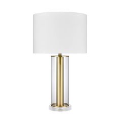 a table lamp with a white shade on the top and gold trimming around it