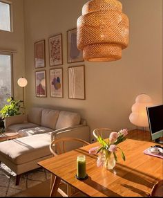 a living room filled with furniture and a wooden table next to a window covered in pictures