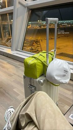 a person sitting on the floor with their luggage