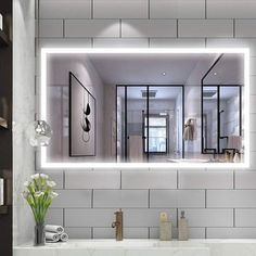 a bathroom with a sink, mirror and flowers on the counter in front of it