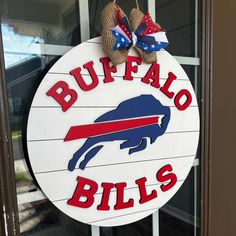 a buffalo bills sign hanging on the side of a door with two burlap shoes