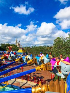 an amusement park filled with lots of colorful rides and people riding on top of them