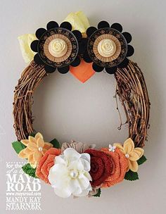 a wreath with flowers and an owl on it