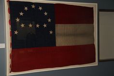 an old american flag hanging on the wall