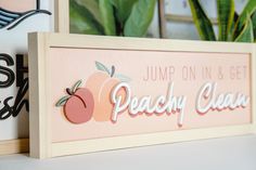 a sign that says jump on and get peachy clean next to a potted plant