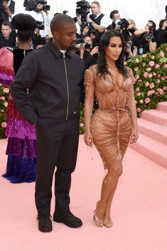 kimye and rapper khle are posing for the cameras on the pink carpet