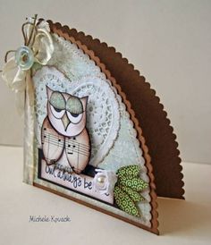 an owl is sitting on top of a card