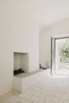 an empty room with a fireplace and sliding glass doors