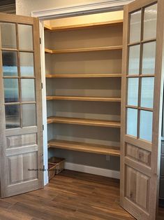 an empty walk in closet with two doors open to reveal another room that has wood floors