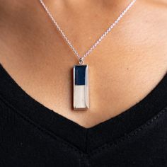 Elevated with an edge, Nechelle is our take on a classic bar pendant. Crafted from sterling silver and repurposed vinyl from the home dugout, it’s a framed piece of wearable art. Style it solo or layer it up to make a statement! Sterling silver Vinyl from the Detroit Tigers’ Dugout 30mm x 10mm pendant Adjustable chain 16, 17, and 18 inches in length We’re proud to collaborate with the Detroit Tigers to produce a limited collection made from repurposed vinyl from the Comerica Park Dugout. Read mo Comerica Park, Classic Bar, Pink Out, Bar Pendant, Detroit Tigers, Necklace Silver, Wearable Art, Tigers, Silver Necklaces