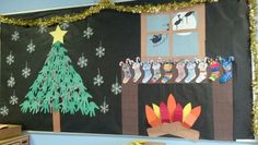 a bulletin board decorated with christmas decorations and stockings hanging from the tree in front of a window