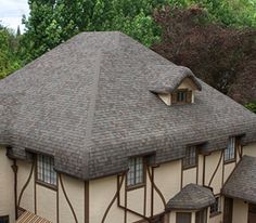 an old style house with a clock on it's side