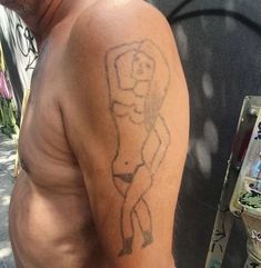 a man with a tattoo on his arm next to a parking meter