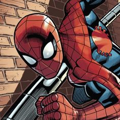 the spider - man is jumping over a brick wall with his arms stretched out to grab something