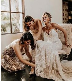 three bridesmaids laughing together on the floor