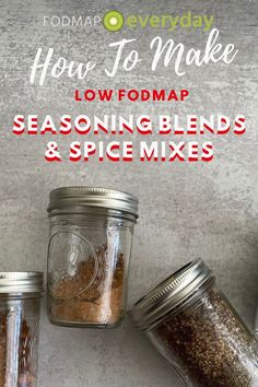 three jars filled with seasoning blends on top of a white counter next to a spoon