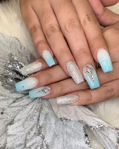 A cool ombre blending frosty blue and white evokes the icy feel of winter, complemented by sparkling glitter accents. The addition of crystal embellishments adds a touch of luxury, while the white snowflakes complete the wintry theme. Perfect for adding a frosty touch to your holiday style. White Snowflake, Holiday Style, Christmas Nail, Sparkles Glitter, Holiday Looks