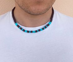 Beaded Choker Necklace for Men, made with uniquely crafted haishi beads, polymer clay beads and real Imperial turquoise stone bead as a centerpiece of the necklace. This necklace is perfect for any boho or surfer type guys who want to add a stylish and edgy accessory to their everyday wear. The brown haishi clay beads are a standout feature of the necklace, giving the piece a raw and natural feel. The small, real turquoise stone bead adds a subtle touch of style to the piece without being too ov Mens Choker, Heishi Jewelry, Beads Polymer Clay, Creative Necklace, Edgy Accessories, Surfer Necklace, Real Turquoise, Handmade Brand, Necklace Turquoise