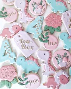 decorated cookies are arranged in the shape of numbers and animals, with flowers on them