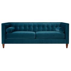 a blue couch with two pillows on the back and one arm upholstered to it