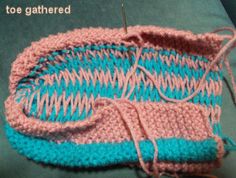 two knitted baskets sitting next to each other on top of a green tablecloth