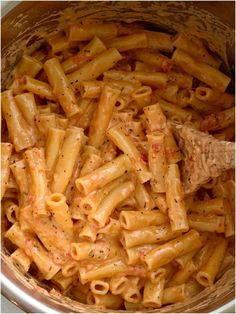 a wooden bowl filled with macaroni and cheese