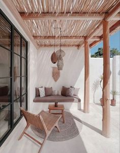 an outdoor living area with wicker furniture