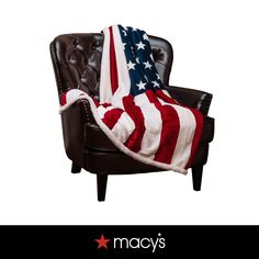 an american flag blanket draped over a leather chair with the words macy's on it