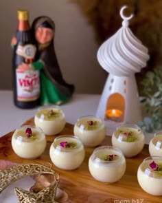 small desserts are arranged on a wooden platter