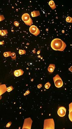 many lanterns floating in the air at night