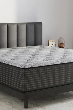 an image of a mattress on top of a bed in a room with white walls