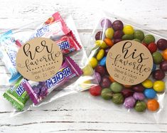 two bags filled with candy sitting on top of a wooden table