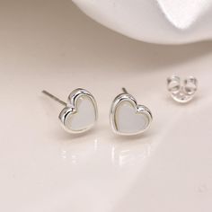 A stunning pair of sterling silver mother-of-pearl heart stud earrings that can be personalised with an optional message on a separate card Not to be found anywhere on the high street, our beautiful heart studs are crafted from the finest sterling silver. Featuring gorgeous natural mother of pearl gemstones set in a beautiful silver heart shaped setting, these dainty silver heart stud earrings feature a classic butterfly and post fastening and are suitable for almost any age. Make your earrings Pearl Heart, Heart Stud Earrings, Pearl Gemstone, Heart Studs, Beautiful Heart, Heart Earrings Studs, Silver Heart, Jewelry Earrings Studs, Mother Of Pearl