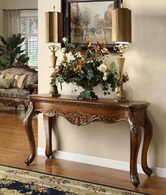 an ornate console table with flowers on it