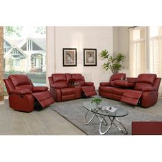 a living room filled with red furniture and a glass coffee table in front of a fireplace