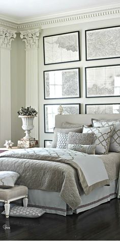 a bed room with a neatly made bed and pictures on the wall