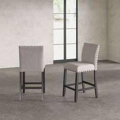 two chairs sitting next to each other in a room