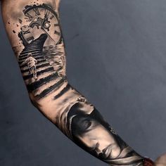 a man's arm with a clock and water scene tattoo on the left forearm