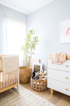 a baby's room with a crib, dresser and bed