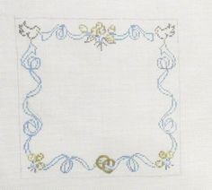 a cross - stitch frame is shown with blue and yellow trimmings on it