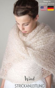 a woman wearing a white shawl with the words wind strickling on it