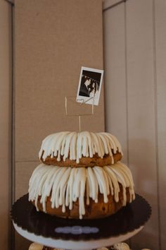 a cake with icing on it sitting on top of a table