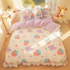 a bed with pink and blue sheets on top of it in a room next to a window