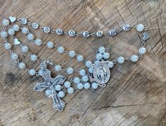 This is  a perfect gift for a Godmother. Hand made very strong rosary. Made with glass pearl beads, beautiful silver plated hearts with the word GODMOTHER on the rosary, Stainless steel and silver plated Findings, a traditional Rosary Centerpiece and a traditional Catholic crucifix.  All of my Rosaries are handmade by myself. I take pride in my work. I use quality and strong products. I make my Rosaries to last so you can enjoy them and pass them down to future generations!  As always, if you ha Adjustable Silver Rosary For Mother's Day, Mother's Day Rosary With 8mm Beads, Catholic Crucifix, Godmother Gifts, Catholic Rosary, The Rosary, Rosary Catholic, Rosary Beads, Baptism Gifts